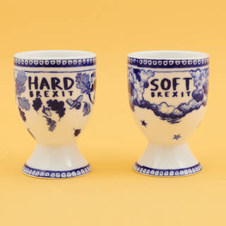 Two white and blue eggcups. One says 'HARD BREXIT' and has acorns and leaves. The other says 'SOFT BREXIT' and has clouds