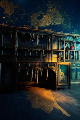 View of the gold fireplace with stalactites and paint on the floor, inside Darren Waterston's Filthy Lucre installation.