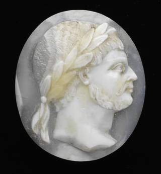 White shell carving of  the side of a Roman Emperor's face