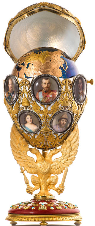 Elaborate open gold Faberge easter egg on stand with portraits of the Russian royal family on surface, showing globe within