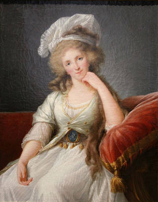 Painting of a woman sitting in a red chair, with her hand on her chin. She has long hair and wears a white hat and white dress. 