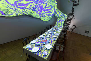 Interior exhibition view showing the digital tea-party projection