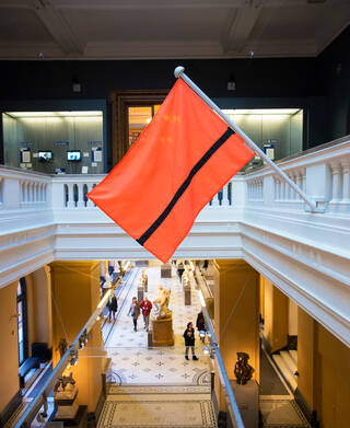 Orange flag with a black line through it