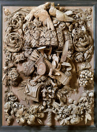 Highly detailed carved wooden panel featuring flora and fauna, two doves, fruit, sword hilts and crowns. 