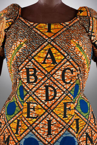 Brightly coloured dress featuring the alphabet