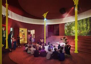 A performer talks to a group of children