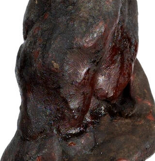 Reddish-brown blob with fingerprints visible. 