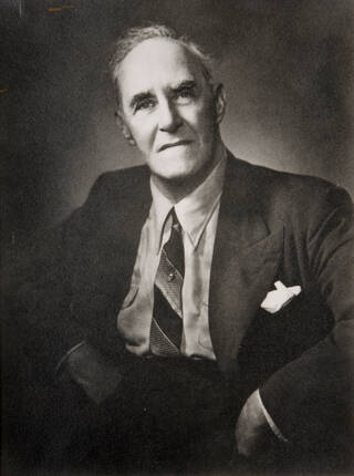 Black and white photograph of man in suit and tie