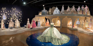 Wide-angle view of room with mannequin dressed in period gowns