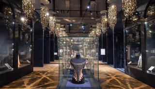 wide angle view of a room with a corset in a case in the centre