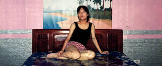 Girl sitting on a bed