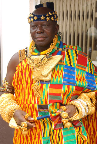 Asante King wearing colourful Kente cloth and lots of gold 
