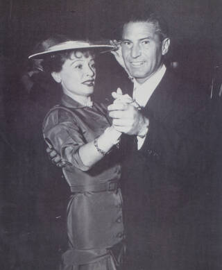 Black and white photograph of a couple dancing, photographed from the waist up
