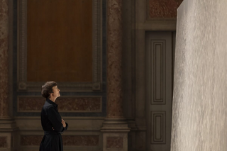 Woman looking at cascade of liquid clay