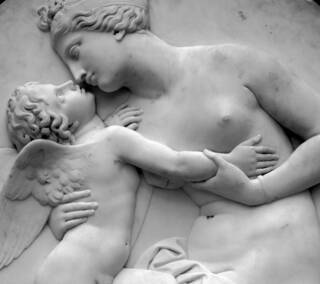 Image of a sculpture panel featuring woman and child in shades of grey